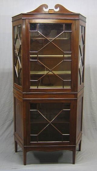 A 19th Century inlaid mahogany diamond shaped cabinet on cabinet enclosed by astragal glazed panelled doors, raised on square tapering supports 43"