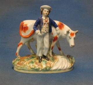 A 19th Century Staffordshire figure of a standing cowman and cow (hat R and cows ear F) 7"