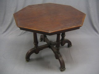 A Victorian octagonal mahogany occasional table raised on turned and fluted supports 36"