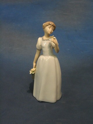 A Nadal figure of a girl with basket of flowers, base marked Nadal 8"