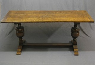 A 1930's oak refectory dining table, raised on bulbous turned supports united by an H framed stretcher 67"