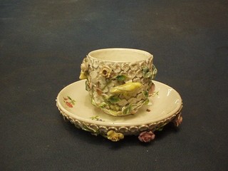 A 19th Century Continental porcelain cup and saucer with floral encrusted decoration (f and r)