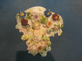 A 19th Century Sampson porcelain wall bracket with floral encrusted decoration supported by a cherub 7"  (heavily f)