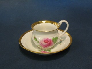 A Meissen cabinet cup and saucer of baluster form decorated roses (chip to rim and handle f), the base with cross swords marked and impressed N91