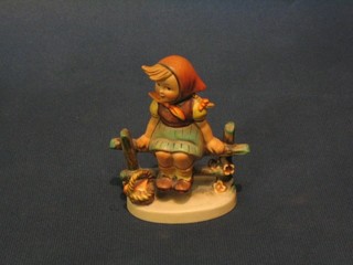 A Hummel figure of a seated girl on bench with basket