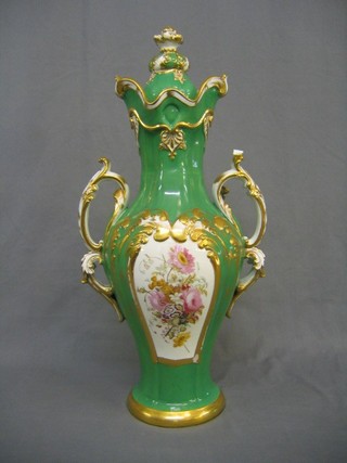 A handsome green glazed porcelain twin handled urn and cover with floral panel decoration 24"