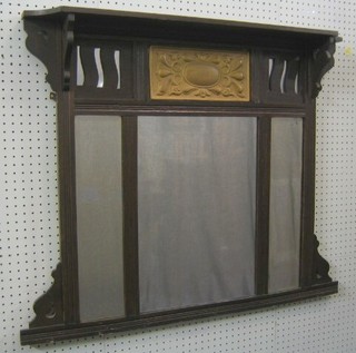 An Edwardian Art Nouveau triple plate over mantel mirror contained in an oak frame 35"