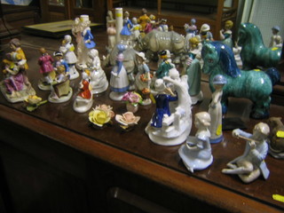 A pottery figure of a rhinoceros and a collection of various pottery figure groups etc