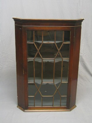 A Georgian mahogany hanging corner cabinet with moulded and dentil cornice the interior fitted shelves enclosed by astragal glazed panelled doors, 31"