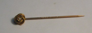 A gold cased stick pin set a pearl