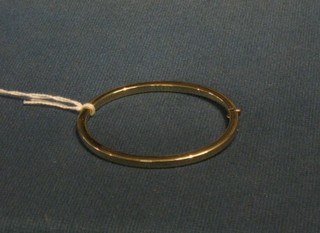 A modern 9ct gold bangle