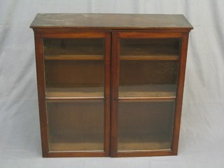 A 19th Century mahogany hanging cabinet, the interior fitted adjustable shelves enclosed by glazed panelled doors 32"