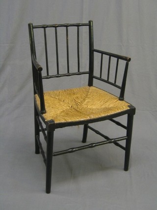 A Victorian ebonised faux bamboo carver chair with woven rush seat