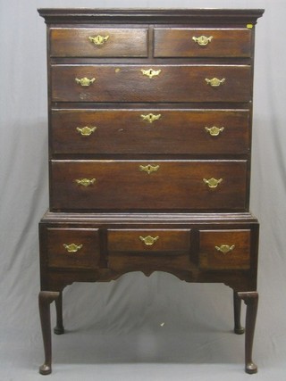 An 18th Century oak chest on stand with moulded cornice, the upper section fitted 2 short and 3 long drawers with brass plate drop handles, the base fitted 1 long drawer flanked by 2 short drawers, raised on club supports 39"