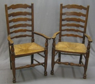 A pair of 20th Century elm ladderback dining chairs with woven rush seats