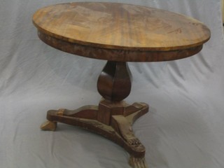 A 19th Century Continental circular breakfast table raised on a shaped column and triform base 41"
