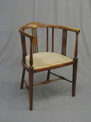 An Edwardian inlaid mahogany tub back chair raised on square supports