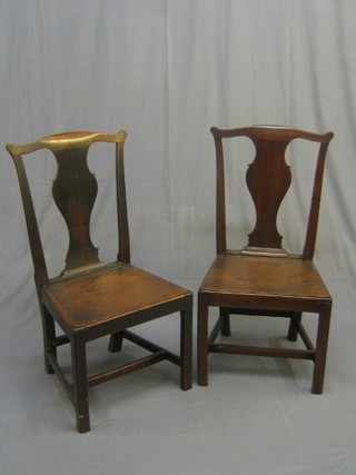 A pair of 18th/19th Century Queen Anne style Country oak splat back hall chairs with solid seats