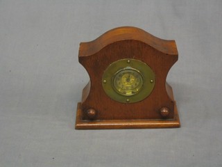 A 1930's 8 day timepiece contained in a shaped mahogany case