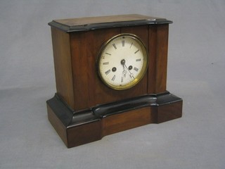 A 19th Century French 8 day striking mantel clock contained in a walnut finished case