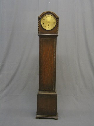 A 1930's oak Granddaughter clock,  the silvered dial marked Waring & Gillow Ltd (movement f) 52"
