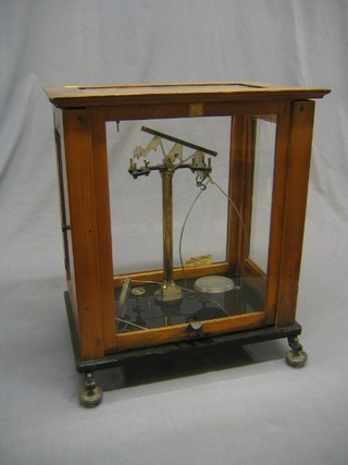 A pair of laboratory scales contained in a mahogany case