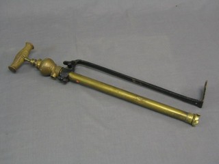 An old brass and iron stirrup pump marked Fourcaks