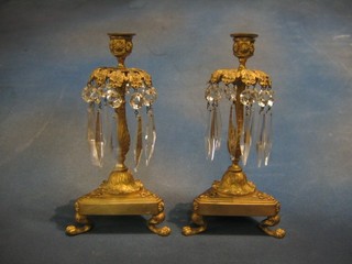 A pair of 19th Century gilt metal lustres, raised on triangular bases 11"