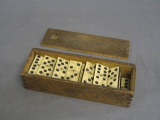 A set of dominoes contained in a wooden box
