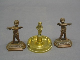 A pair of gilt metal figures of standing cherubs (formerly holding trays f) 5" and a circular brass ashtray 5"