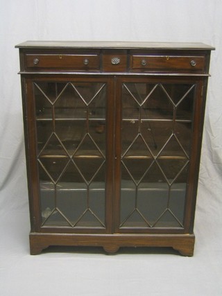 An Edwardian mahogany bookcase, the upper section fitted 2 drawers, the shelved interior enclosed by astragal glazed panelled doors, raised on bracket feet 39"