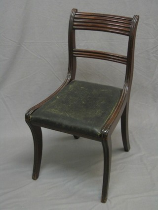 A Georgian mahogany bar back dining chair with plain mid rail and upholstered drop in seats, raised on sabre supports