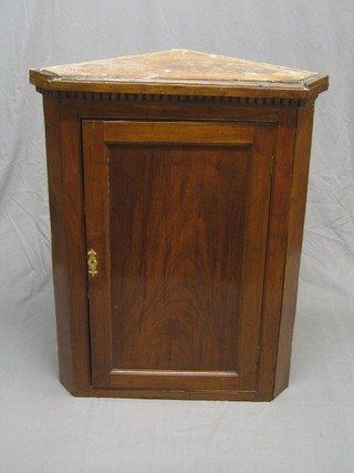 A Georgian  mahogany hanging corner cabinet with moulded and dentil cornice, the interior fitted shelves enclosed by a plain panelled door, 32"