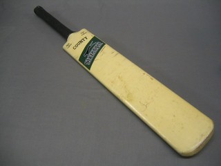 A Slazenger long handled cricket bat signed by the 1976/77 England and Australia Ashes cricket teams