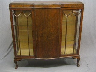 A 1930's Georgian style mahogany display cabinet having centre cupboard enclosed by a panelled door, flanked by a pair of cupboards enclosed by astragal glazed panelled doors, raised on cabriole supports 46"