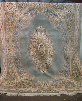A green ground and floral patterned Chinese carpet 146" x  109"