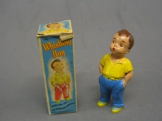 A plastic clock work figure of The Whistling Boy, boxed