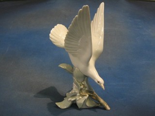 A Lladro figure of a diving bird, base impressed F25M (foot f)  11"