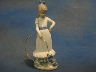 A Nao figure of a standing girl with hoop, base marked B17M 10"