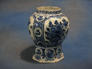An 18th Century Delft blue and white urn of club form decorated birds amidst branches, some chips to the top and base, 9"