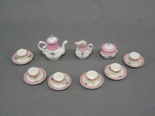 A child's 9 piece dolls house coffee service comprising coffee pot, cream jug (chipped) 6 cups and 6 saucers (1 handle missing from cup), twin handled sucrier (f)