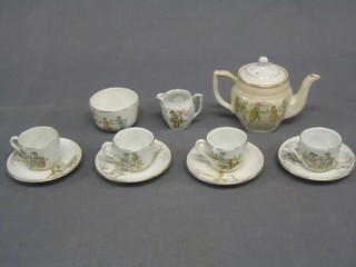A childs 7 piece miniature tea service comprising teapot, sugar bowl, cream jug, 4 cups and saucers (1 cup chipped)