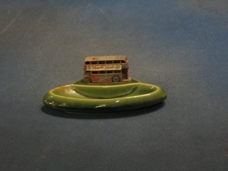 A green glazed Wade ashtray decorated a metal model of a No.5 London Double Decker bus