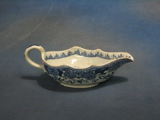 A 19th Century Oriental blue and white porcelain sauce boat decorated pagodas 8" (1" chip to base)