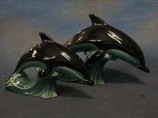 A blue glazed Poole pottery figure of a dolphin 9" and 1 other 11"
