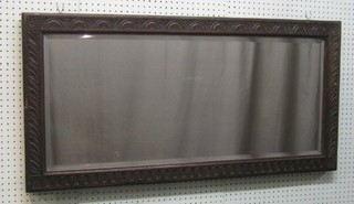 A Victorian rectangular bevelled plate mirror contained in an oak frame 45"