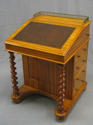 A Victorian satinwood Davenport desk with pierced brass three-quarter gallery, the pedestal fitted an inkwell above 4 long drawers, raised on spiral turned columns, 25"