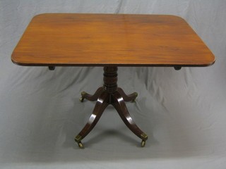 A Regency rectangular breakfast table, raised on pillar and tripod supports ending in brass caps and castors 48"