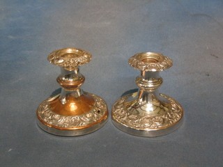 A pair of circular embossed silver plated stub candlesticks 3" (1 with hole)
