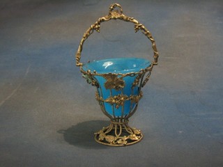 A Continental white metal bon bon dish with pierced vinery decoration and blue glass liner